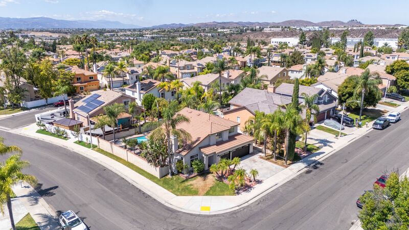 Aerial neighborhood panorama with homes and surrounding landscape