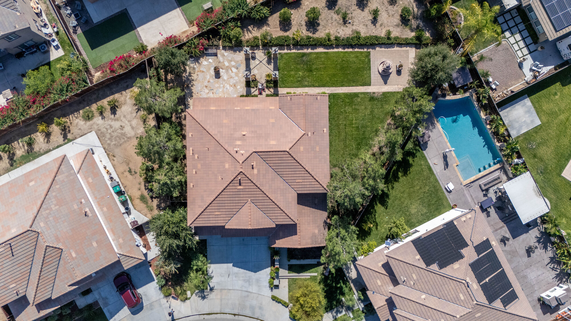 Top-down aerial view showing a home, yard, and surrounding lots
