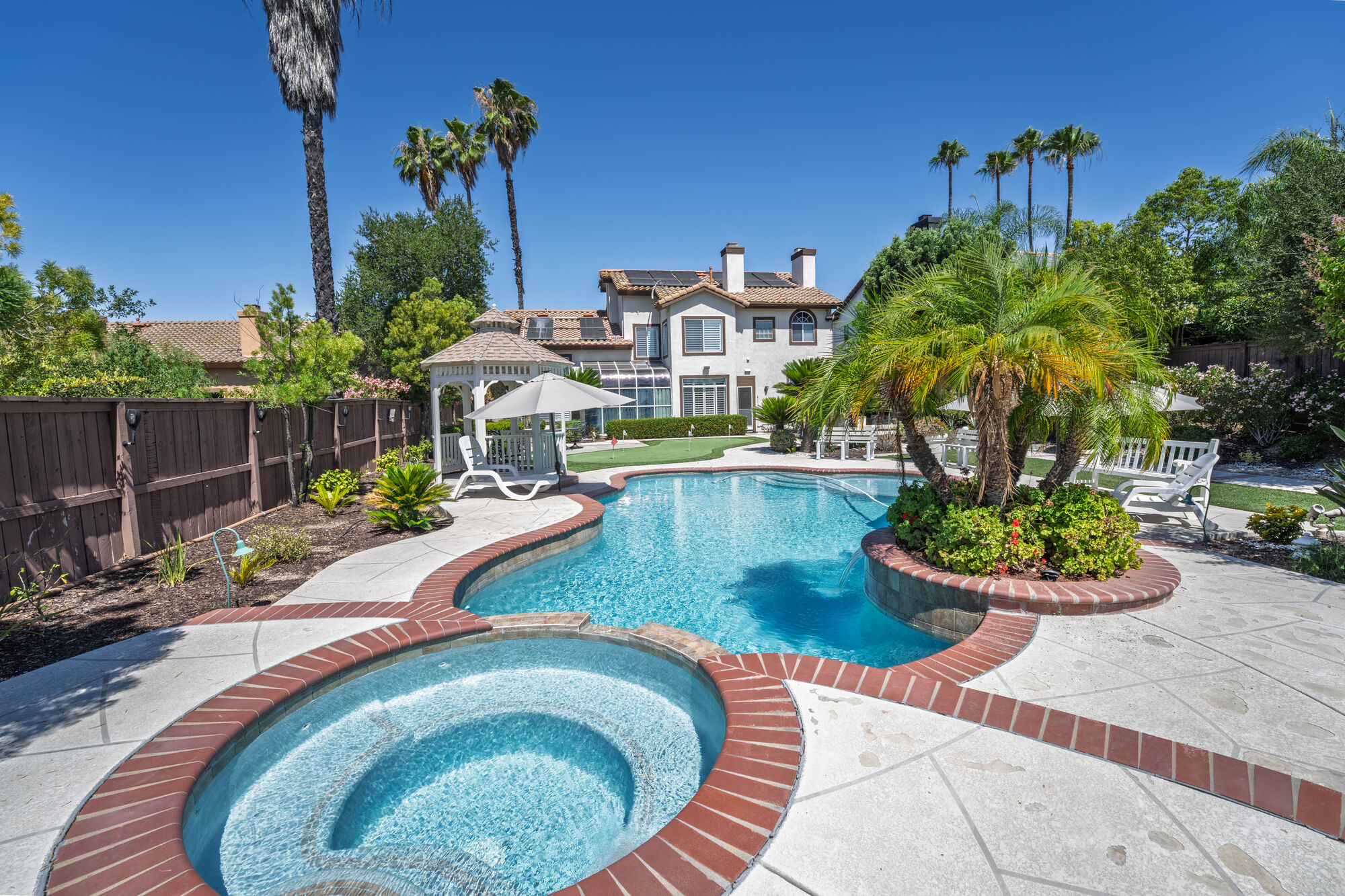 Backyard pool and spa photographed in bright Southern California light
