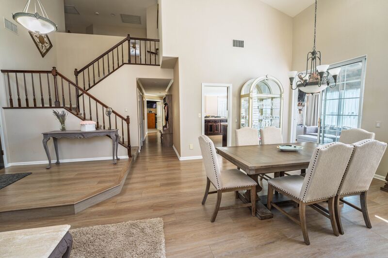 Two-story entry and dining area with an open staircase