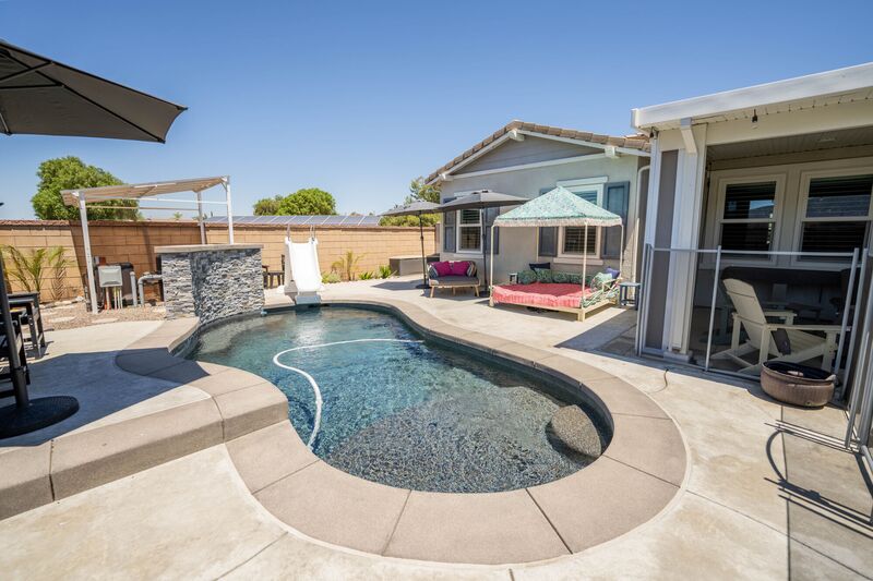 Backyard swimming pool with a pergola
