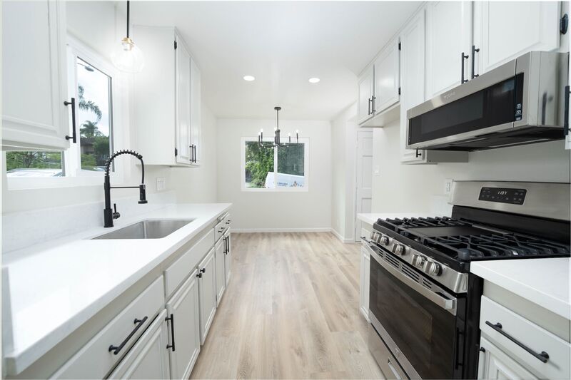 Renovated white kitchen with gold fixtures