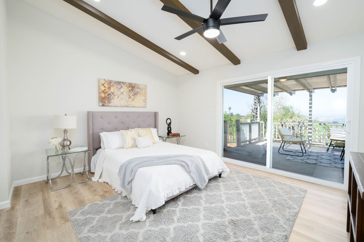 Staged bedroom with ceiling beams prepared for a professional property shoot